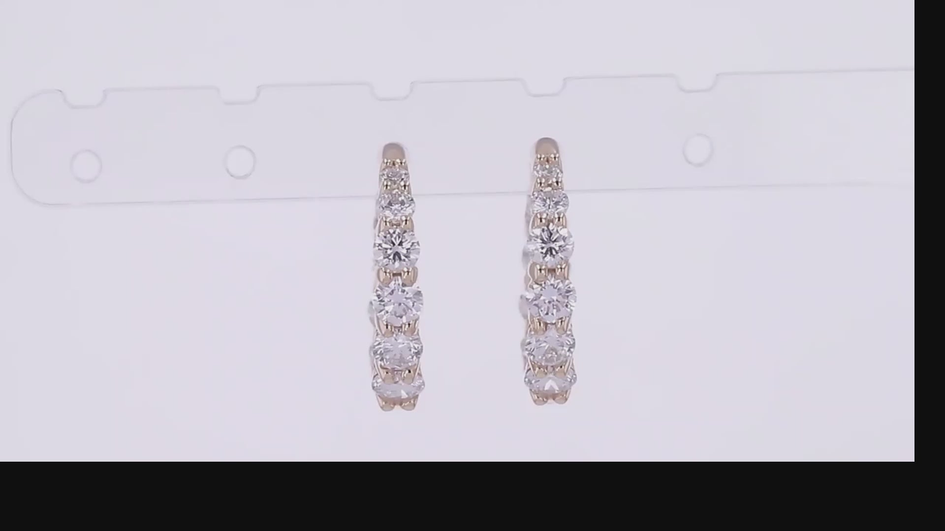 Graduated lab diamond huggie hoop earrings in 18k gold by Brilliana